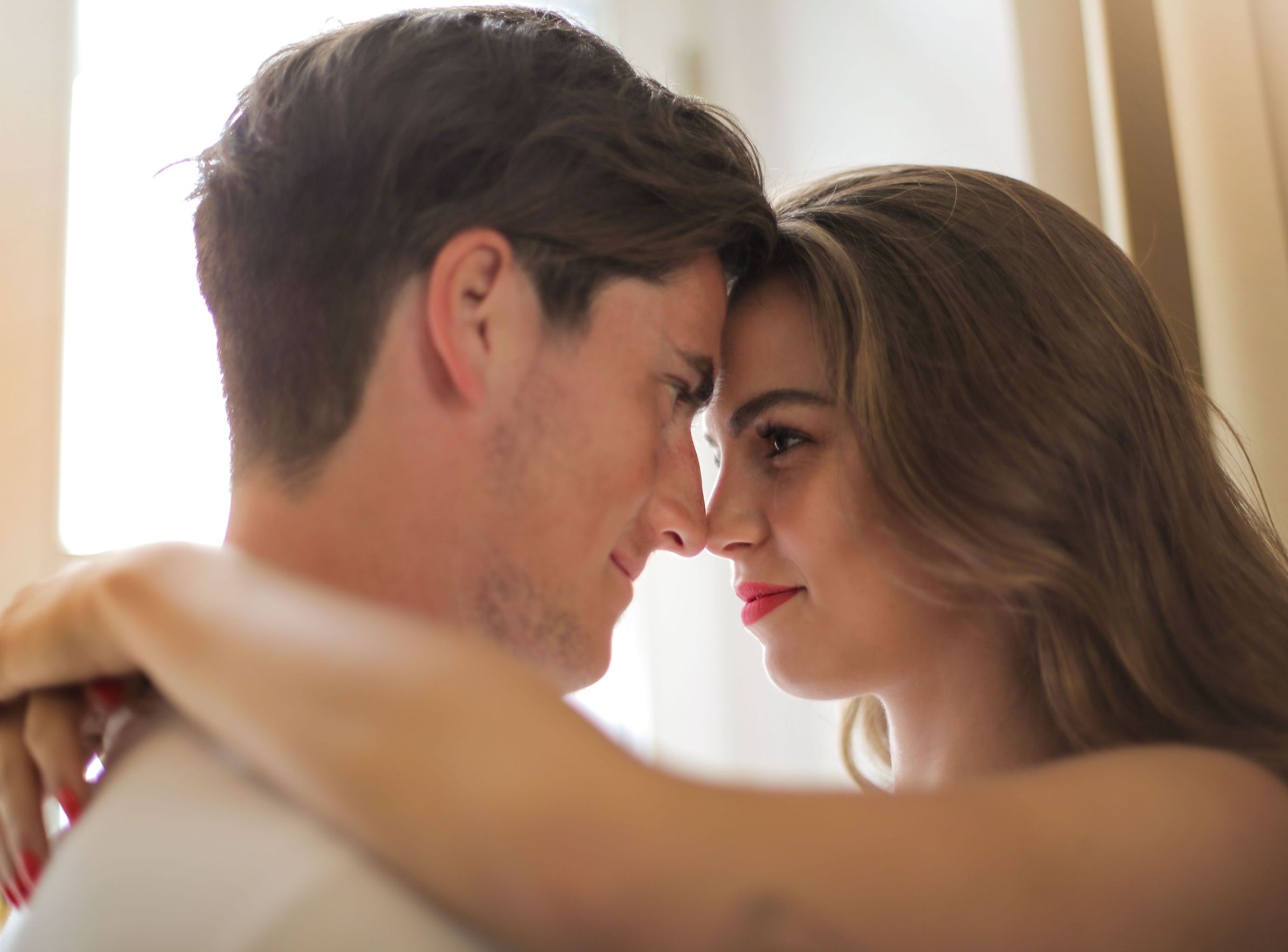 A couple gazes lovingly at each other during an intimate moment.