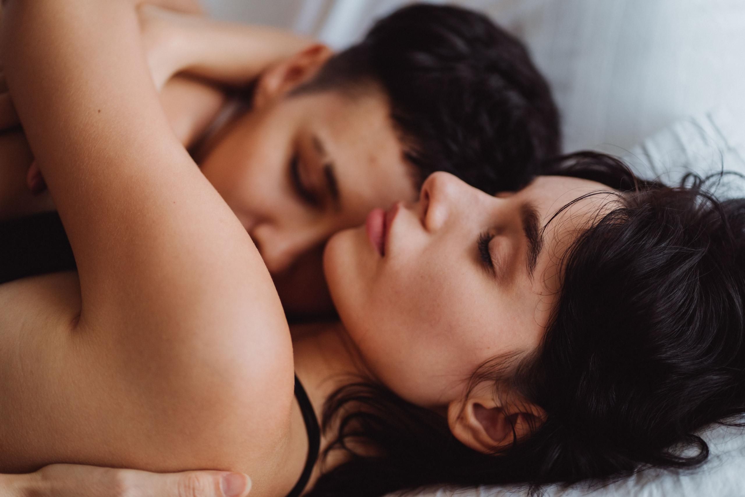 Two women cuddling in a bed